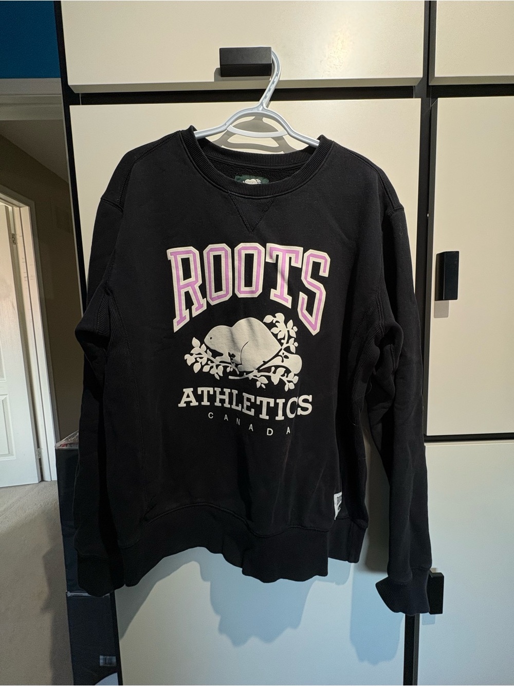 Roots Black Crewneck Sweatshirt with Pink-Outlined Logo